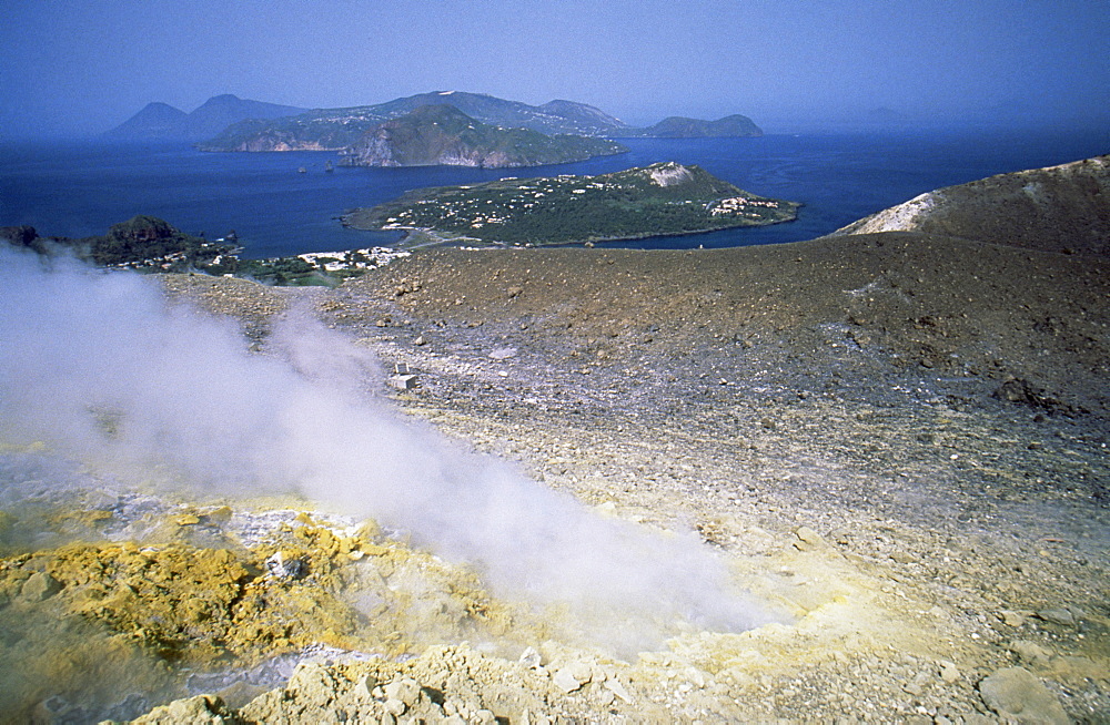 Steam issuing from sulphurous fumarole at Gran Craters, Vulcano Island, with islands of Lipari and Salina beyond, Aeolian Islands (Eolian Islands) (Lipari Islands), UNESCO World Heritage Site, Sicily, Italy, Mediterranean, Europe