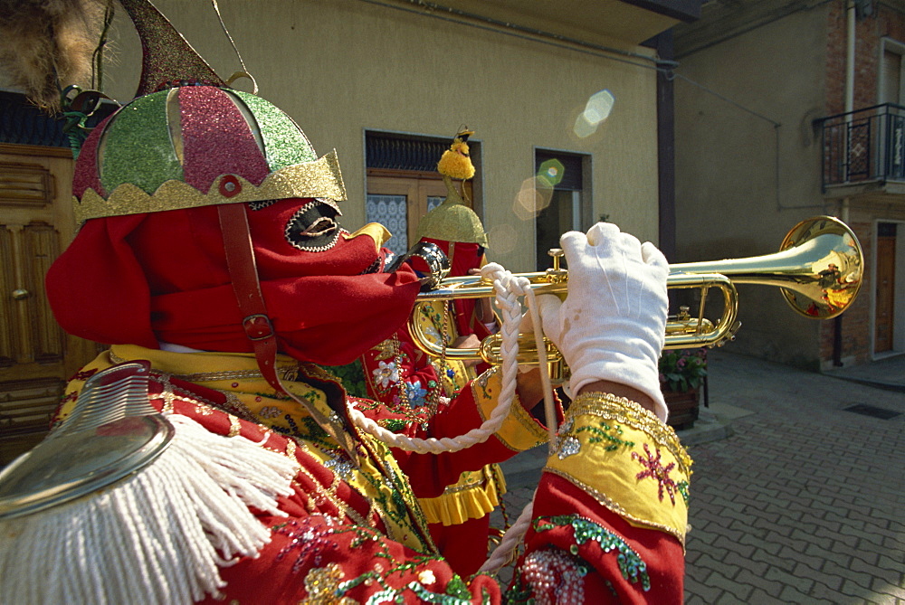 Trumpet player in red costume and mask celebrates the Feast of the Jews, just before Easter, in the Lombard village of San Fratello, north Sicily, Italy, Europe