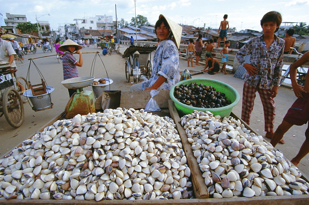 Man selling shellfish and snails on bridge, Ho Chi Minh City (formerly Saigon), Vietnam, Indochina, Southeast Asia, Asia