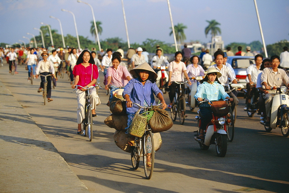 Cyclists in morning rush hour on Phu Xuan bridge, Hue, Vietnam, Indochina, Southeast Asia, Asia