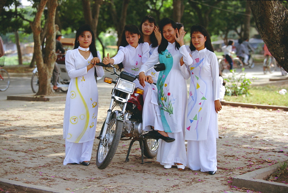 Group of college girls wearing traditional ao dai at West Lake (Hoy Tay) on graduation day, Hanoi, Vietnam, Indochina, Southeast Asia, Asia