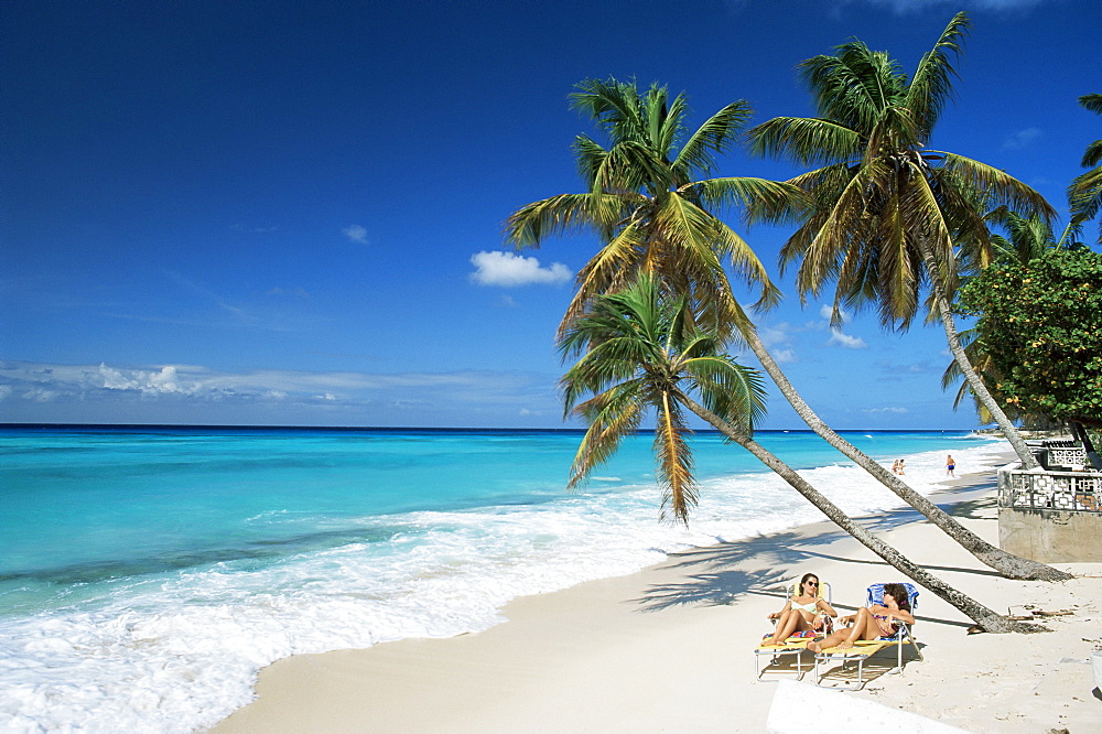 Sunbathers on Worthing Beach, on the south coast, Christ Church, Barbados, West Indies, Caribbean, Central America