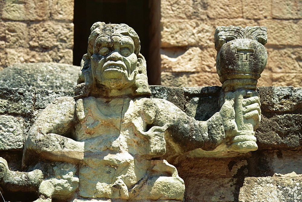 The Mayan rain god Chac, holding burning torch showing his power to withhold or dispense rain, in west court of the Mayan ruins at Copan, UNESCO World Heritage Site, western highlands, Honduras, Central America