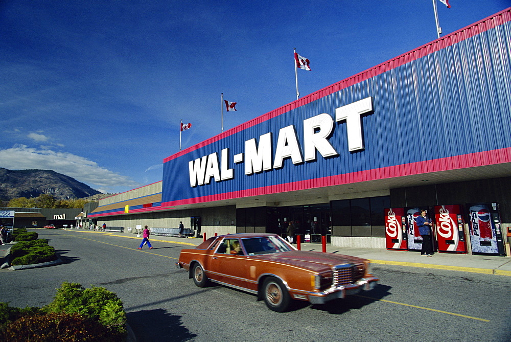 Car and Coke machines outside Wal-Mart, one of the largest general store chains in North America, at Penticton, British Columbia, Canada, North America