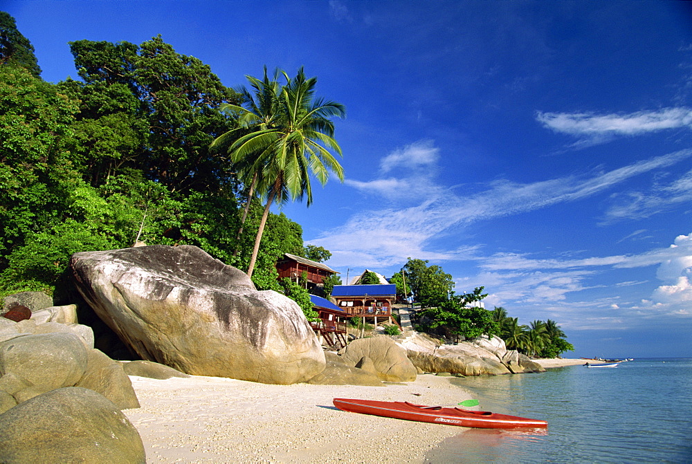 Houses and kayak on tropical beach on Perhentian Besar, larger of two Perhentian Islands with marine parks off the coast of Terengganu, Malaysia, Southeast Asia, Asia