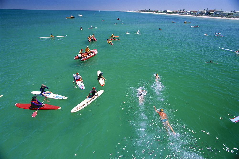 Competitors leaving Grange Pier at the Henley and Grange swimming race that is swum between the piers of these two seaside suburbs of Adelaide, South Australia, Australia, Pacific