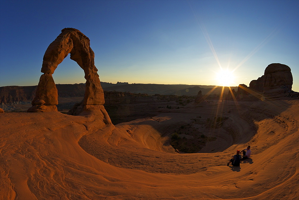 Two men sitting, Delicate Arch, Arches National Park, Moab, Utah, United States of America, North America 