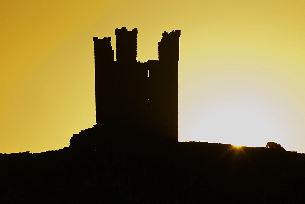 Dunstanburgh Castle at dawn, Northumberland, England, United Kingdom, Europe 