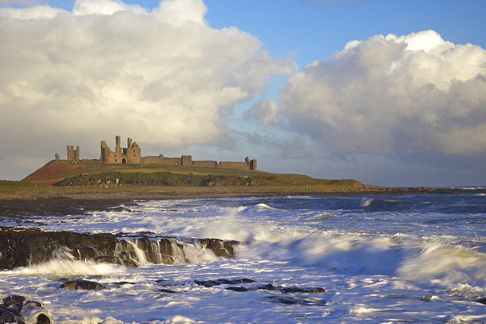 Surf on rocks, Dunstanburgh Castle, Northumberland, England, United Kingdom, Europe 