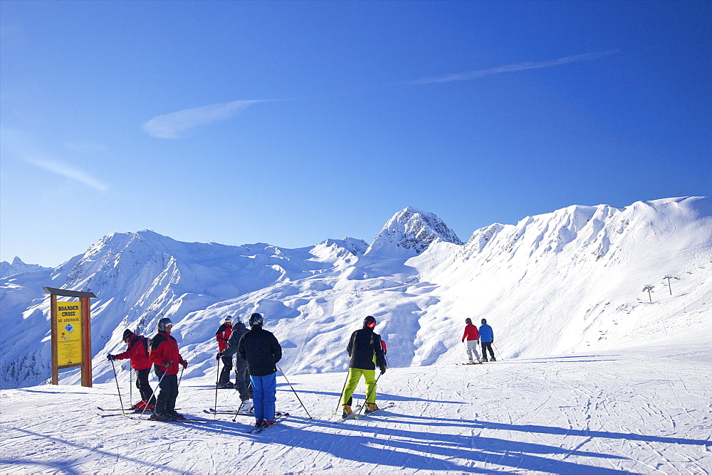 Skiers on piste early morning in winter, La Plagne, French Alps, France, Europe 