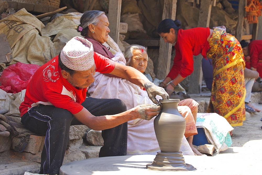 Potter turning pot on wheel, Potter's Square, Bhaktapur, Nepal, Asia