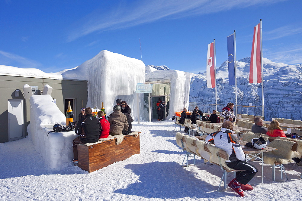 Skiers enjoying drinks at the Icebar Lech near St. Anton am Arlberg in winter snow, Austrian Alps, Austria, Europe