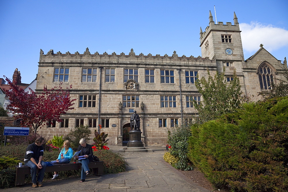 Visitors sitting in front of Statue of Charles Darwin outside Public Library, Shrewsbury, Shropshire, England, United Kingdom, Europe