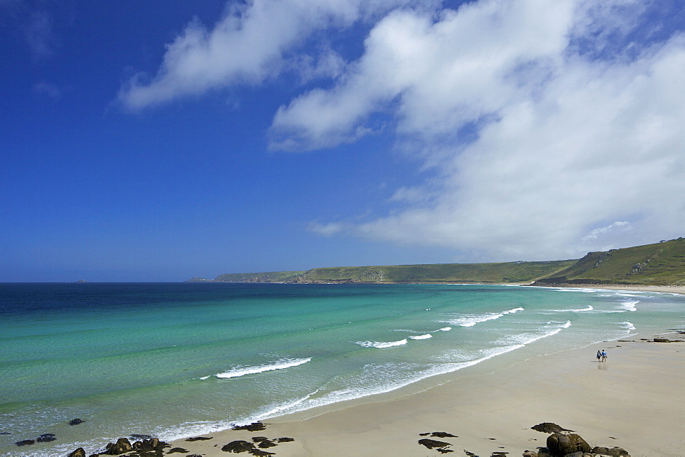 Young couple on beach at Sennen Cove in summer sunshine, West Penwith, Cornwall, England, United Kingdom, Europe