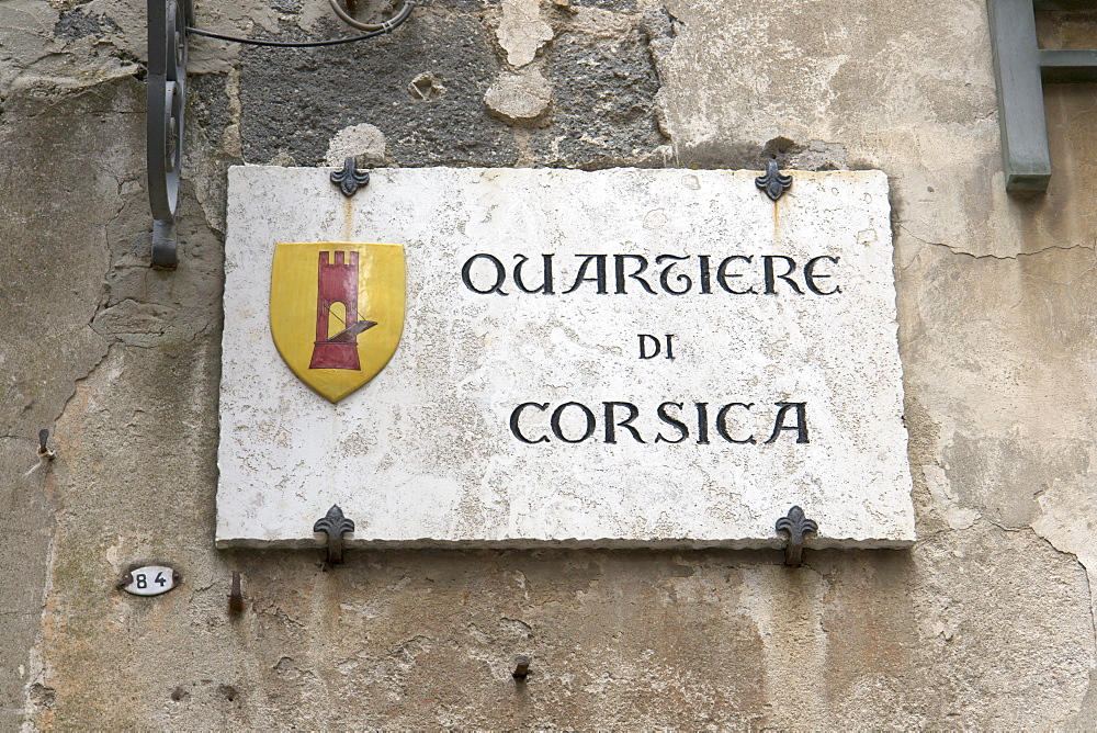 A street sign indicating the border of the "Corsica" quarter in the medieval hill town of Orvieto, province of Terni, Umbria, Italy, Europe