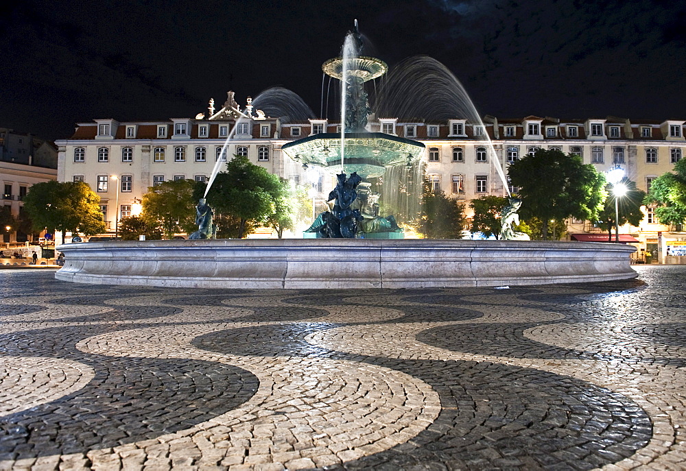 Fountains and wave patterns in the cobblestone pavement on the Rossio square or Praca Dom Pedro IV., Lisbon, Portugal, Europe