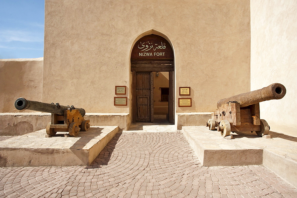 Entrance to the fort of Nizwa with two cannons, Oman, Middle East