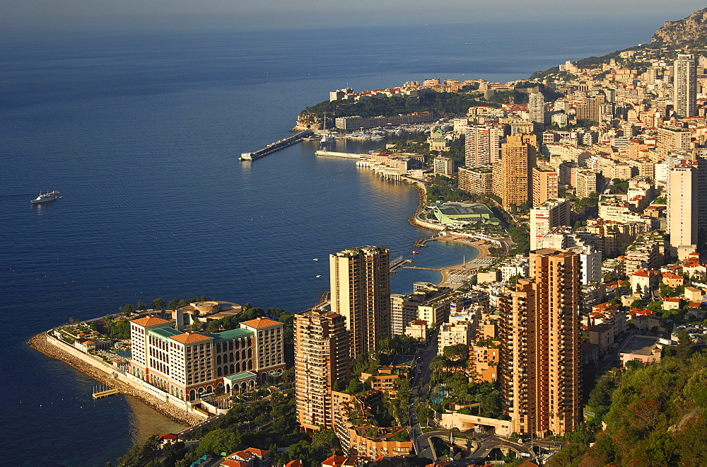 View of the principality of Monaco on the coast of the Cote d'Azur, from left, Monte-Carlo Bay Hotel & Resort, high-rises of Monte Carlo and behind Monaco-Ville, Principality of Monaco, Europe