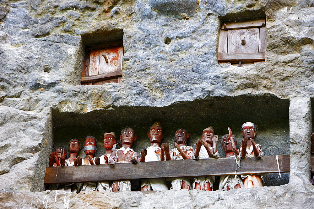 Rock tombs with figures, ancestral gallery, Lemo, Toraja culture, Sulawesi, Indonesia, Asia