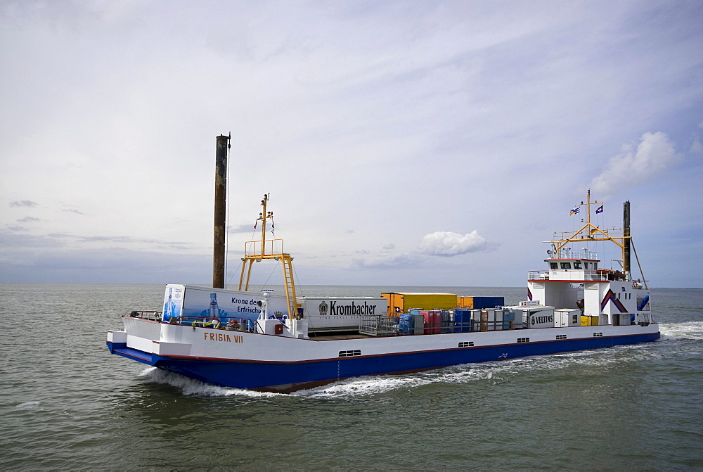 Flat keeled freighter in motion, Frisia VII, with supplies for Juist Island, Lower Saxony, Wadden Sea, Germany, Europe