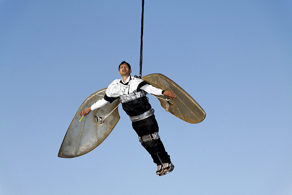 Man with wings hanging on a rope, floating in the air, Global Rheingold, open-air theater by La Fura dels Baus, Duisburg-Ruhrort, Ruhrgebiet area, North Rhine-Westphalia, Germany, Europe