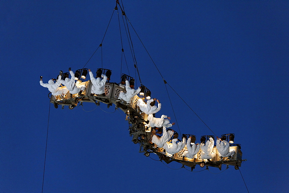 White-clad trapeze artists hanging upside down from a waved platform in the air, Global Rheingold, open-air theater by La Fura dels Baus, Duisburg-Ruhrort, Ruhrgebiet area, North Rhine-Westphalia, Germany, Europe