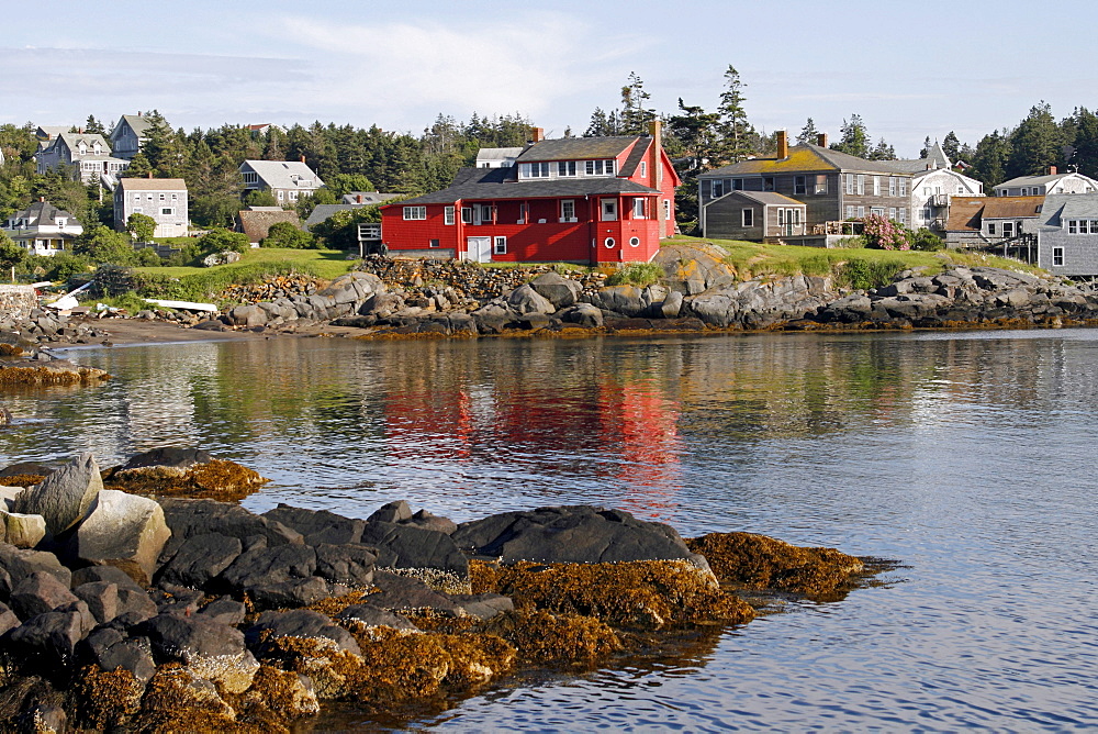 Remote offshore harbor scene, rocky coast, red house, Monhegan Island, Maine coast, New England, USA