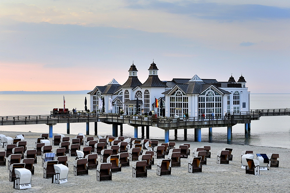 Beach chairs on the sandy beach of the Baltic resort Sellin, in the back the historic pier with restaurant, Ruegen island, Mecklenburg-Western Pomerania, Germany, Europe