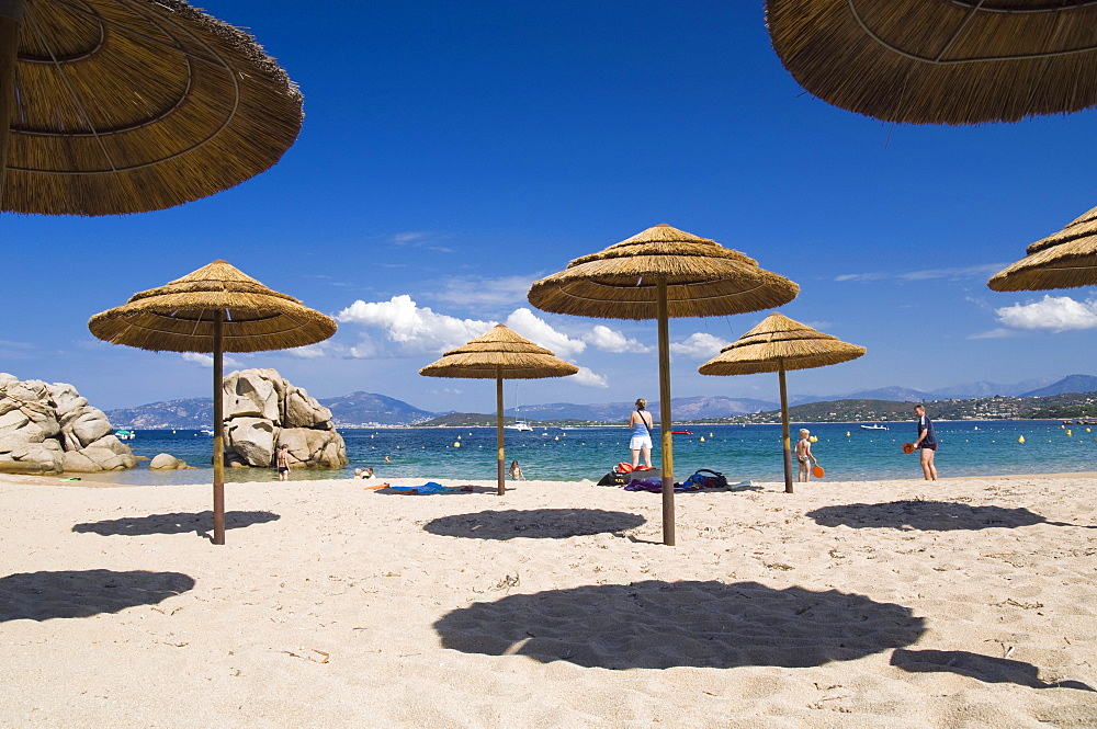 Sun umbrellas on the beach, Plage de Verghia, Gulf of Ajaccio, Corsica, France, Europe