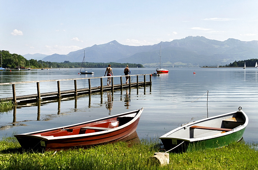 2 small wooden dinghies on the foreshore of lake Chiemsee, Chiemgau, Upper Bavaria, Germany, Europe