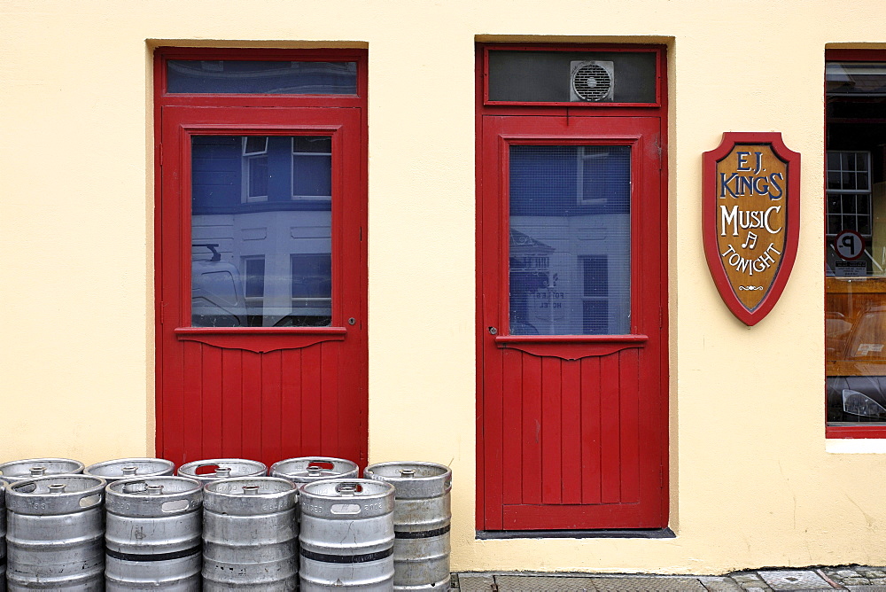 Irish pub with beer kegs in the street, Clifden, Connemara, Republic of Ireland, Europe