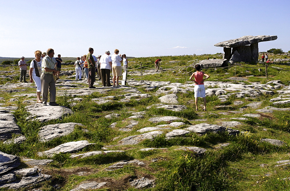 Tourists at the portal tomb, The Burren, Republic of Ireland, Europe