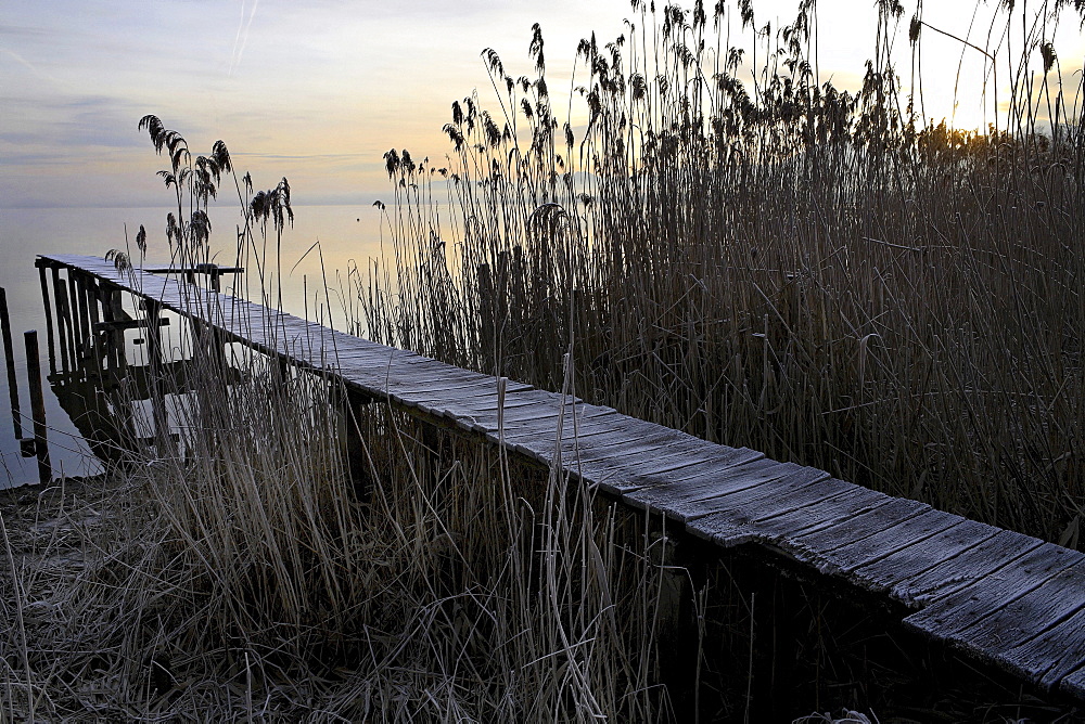 Old wooden jetty covered in early morning frost, lake Chiemsee, Upper Bavaria, Germany, Europe