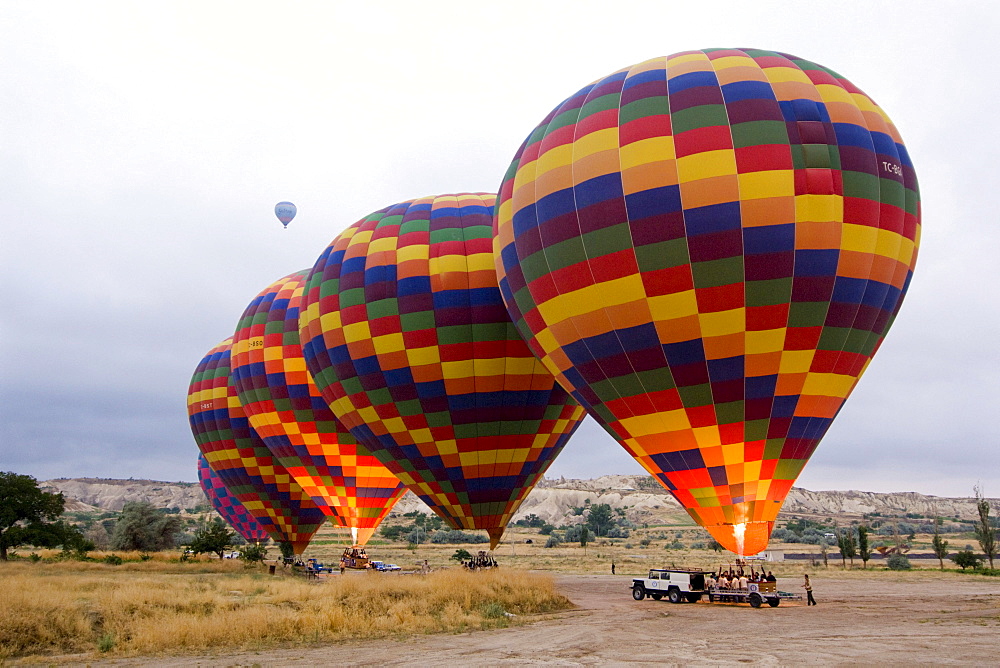 Hot air balloon being prepared for a flight over the tufa landscape of the UNESCO World Heritage Site Goreme, Cappadocia, central Anatolia, Turkey, Asia