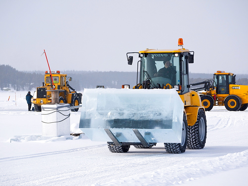 Near the ice hotel in Jukkasjaervi, large blocks of ice are cut and lifted from the frozen Torne Aelv River with heavy equipment, Jukkasjaervi, Kiruna, Lappland, northern Sweden, Sweden, Europe