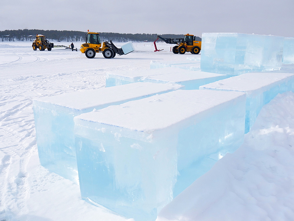 Near the ice hotel in Jukkasjaervi, large blocks of ice are cut and lifted from the frozen Torne Aelv River with heavy equipment, Jukkasjaervi, Kiruna, Lappland, northern Sweden, Sweden, Europe