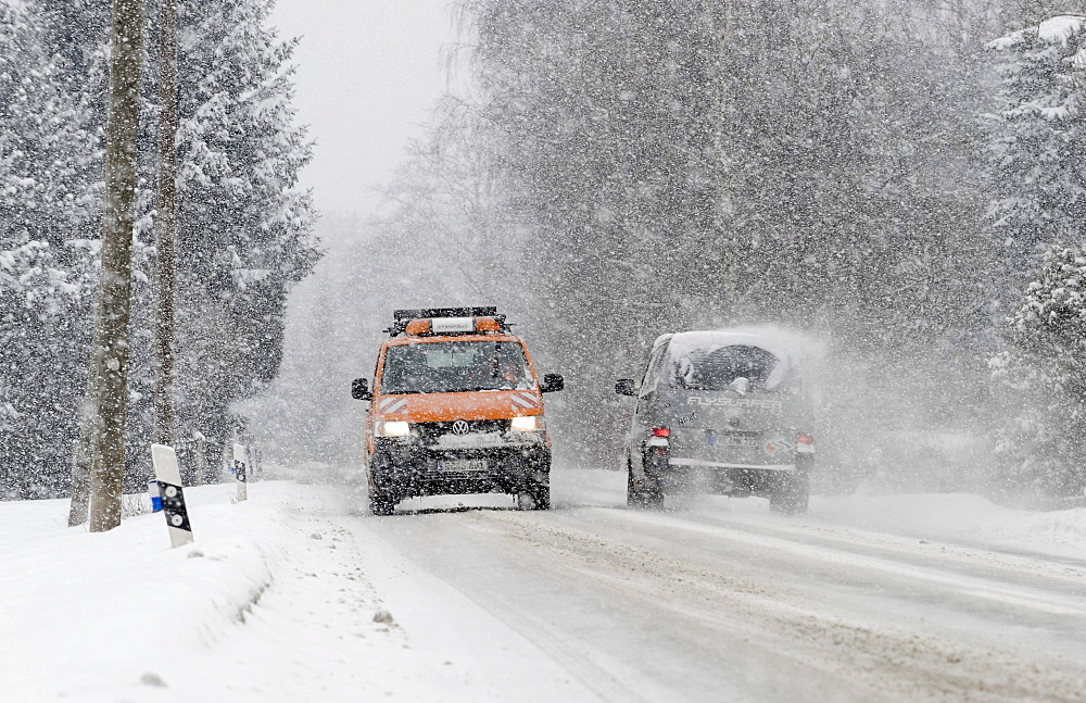 Cars driving on a highway through heavy snowfall in Markt Schwaben, Bavaria, Germany, Europe