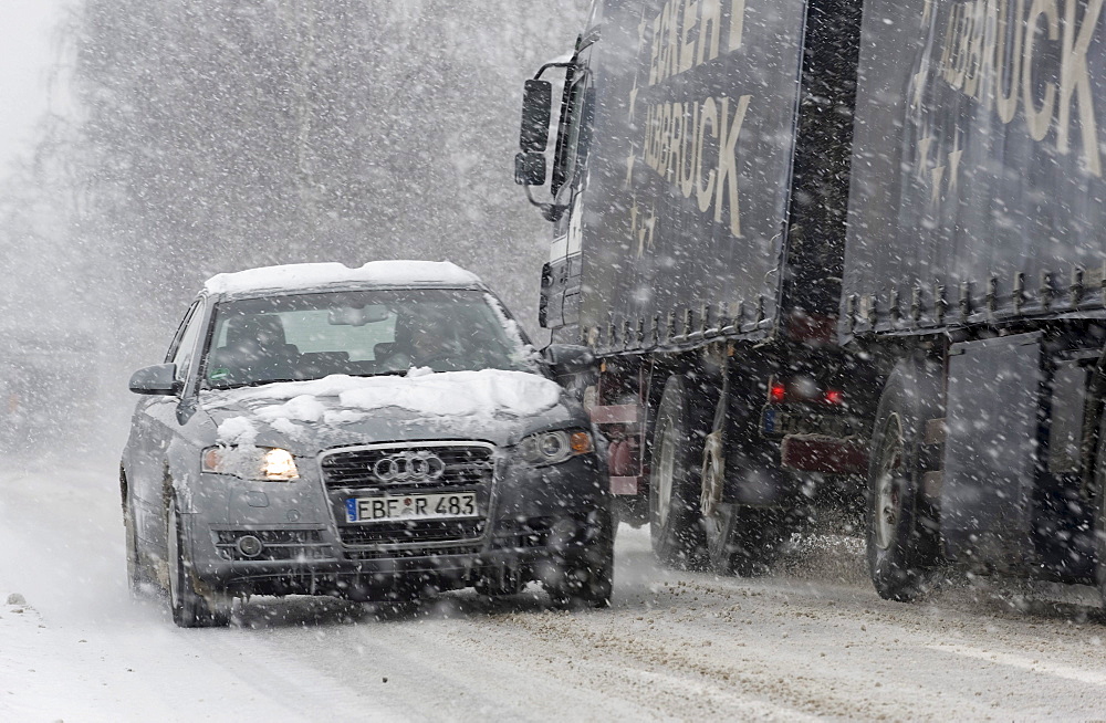 Cars driving on a highway through heavy snowfall in Markt Schwaben, Bavaria, Germany, Europe