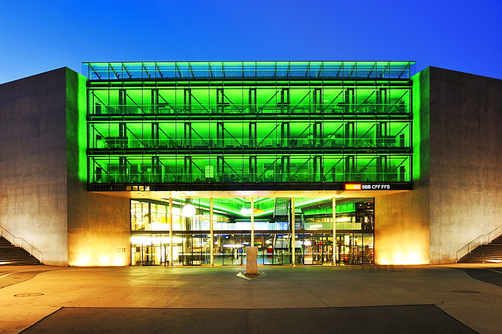 Neon-lit glass facade of the train station in Zug, Switzerland, Europe