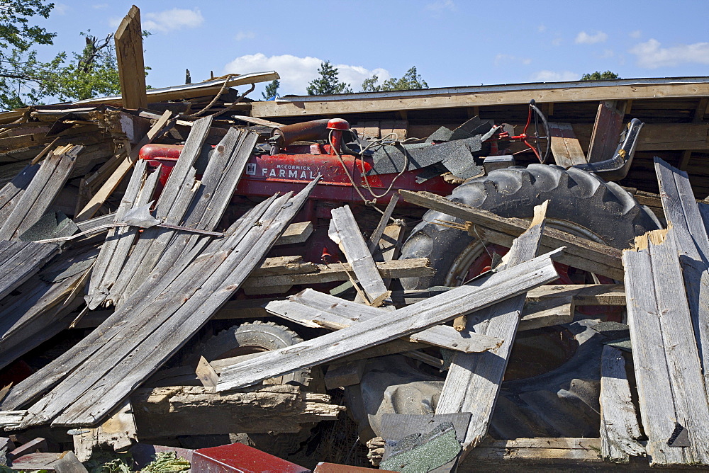 A farm shed collapsed on a tractor by a tornado, Dundee, Michigan, USA