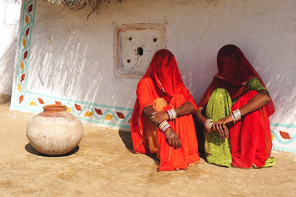 Veiled women talking in front of their house, Thar Desert, Rajasthan, North India, India, Asia