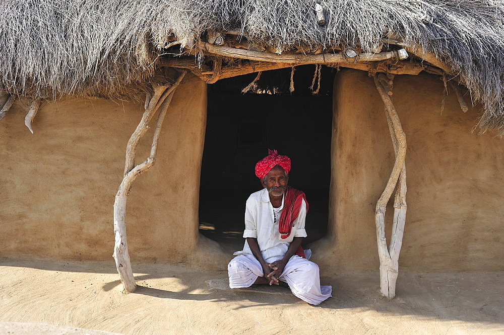 Man with turban at the front door to his house, Thar Desert, Rajasthan, North India, India, Asia