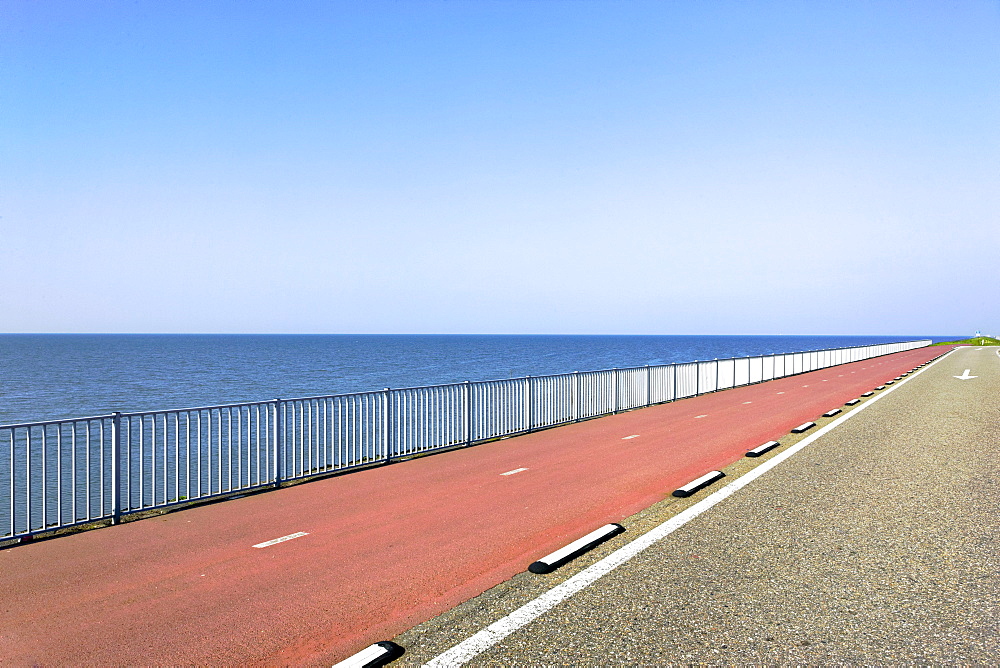 Highway with red asphalt along the sea, Holland, Netherlands, Europe