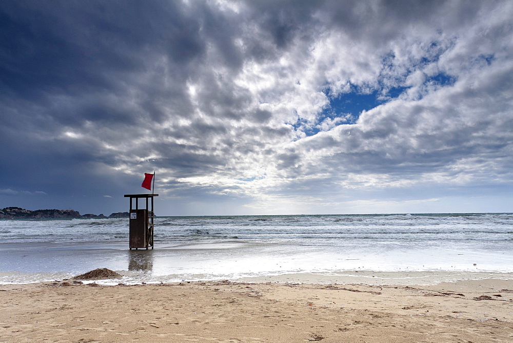 Lifeguard watch tower on the Playa Tora beach with red flag and distinctive clouds, Peguera, Majorca, Balearic Islands, Spain, Europe