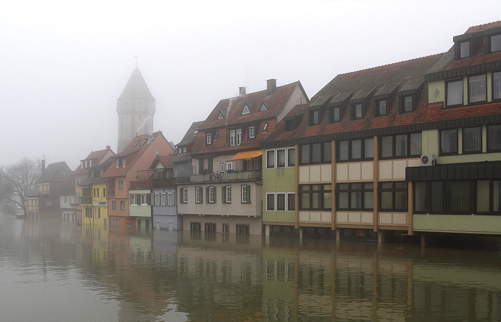 Floodwaters and fog, buildings on the bank of the Tauber river, seen from the Tauber river bridge on Bahnhofstrasse street from direction of Main estuary, Wertheim, Baden-Wuerttemberg, Germany, Europe