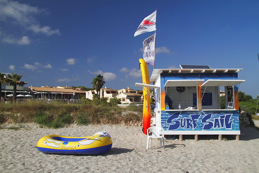 Wooden hut and a yellow rubber boat on Son Xoriguer beach, Menorca, Spain, Europe