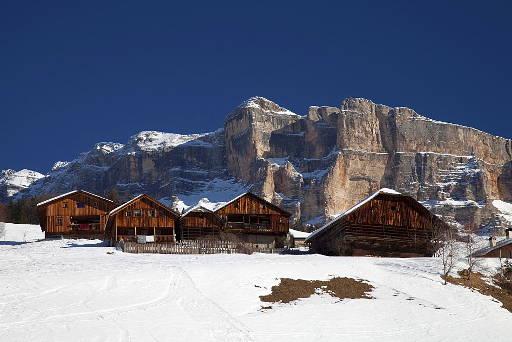 Wooden houses in front of Mt. Heiligkreuzkofel, Fanes mountains, Fanes-Sennes-Prags Nature Park, Val Badia, Alta Badia, Dolomites, South Tyrol, Italy, Europe