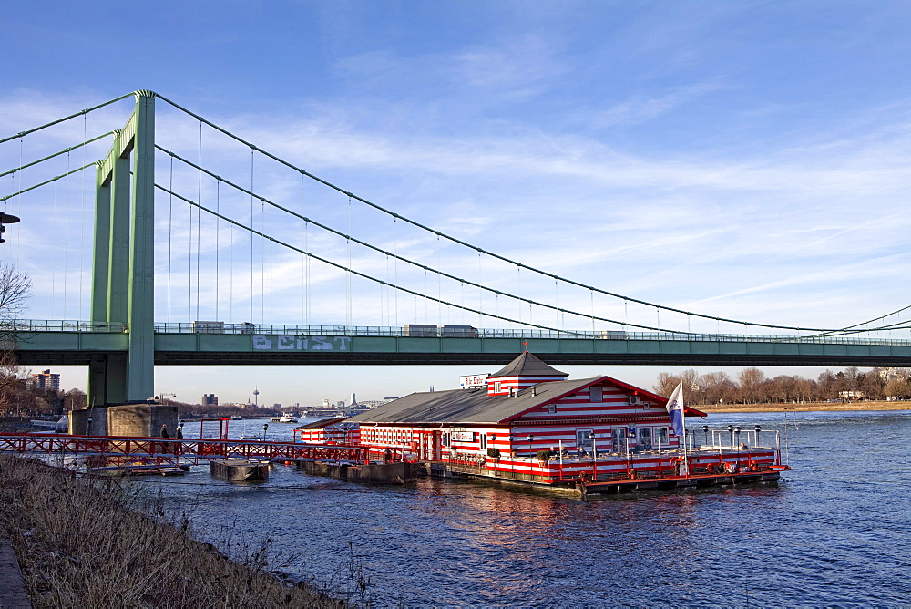 The restaurant ship "Alte Liebe" in front of the Rodenkirchen Rheinbruecke highway bridge over the Rhine, Rodenkirchen, Cologne, North Rhine-Westphalia, Germany, Europe