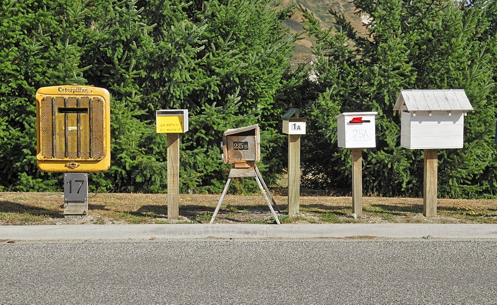 Individual letter boxes lining the access road to a new settlement, Arthurs Point, South Island, New Zealand