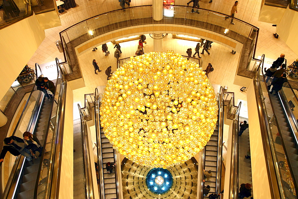 Christmas decorations, many small golden Christmas baubles make up one large Christmas bauble hanging in the staircase of a shopping centre, Essen, North Rhine-Westphalia, Germany, Europe